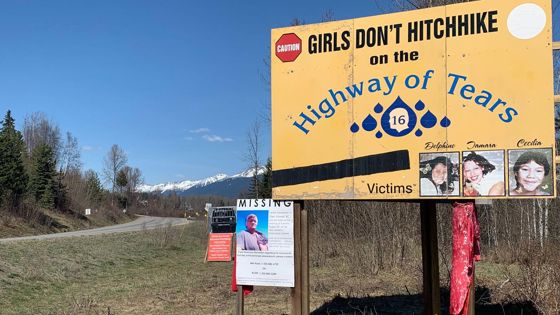 Highway of tears sign advising girls not to hitchhike and pics of some victims